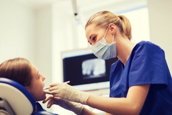 Dental Hygienist examining child's teeth